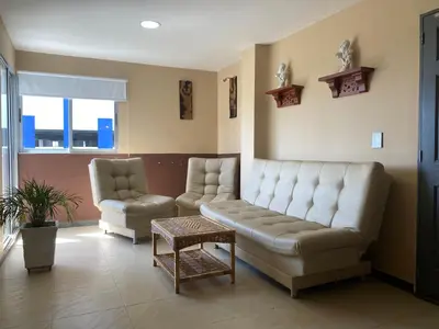 a living room with a couch and a chair at Apartamento Los Lagos in Cartagena de Indias