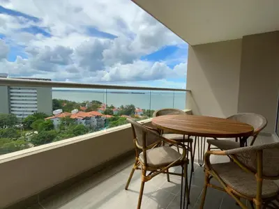 a balcony with a table and chairs and a large window at VISTA BAHIA Santa Marina Santa Marta in Santa Marta
