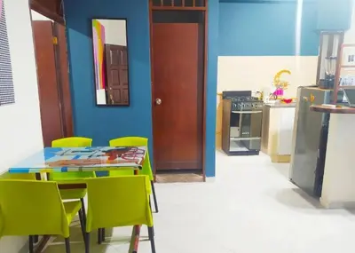 a kitchen with a table and chairs and a blue wall at Acogedor apto en el centro historico - CER in Cartagena de Indias