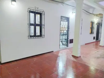 a white room with two barred windows and a brick floor at Acogedor apto en el centro historico - CER in Cartagena de Indias