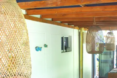 a room with a white door and two hanging lights at MANGO BREEZE Casa de Playa en Tierrabomba in Tierra Bomba