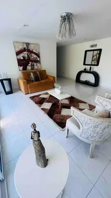 a living room with a dog sitting on a table at Casa a 2 minutos de la playa en playa mendoza in Tubará
