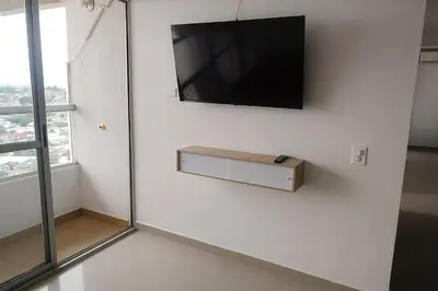 a flat screen tv hanging on a white wall at Cartagena Search in the Historic Center T6 in Cartagena de Indias