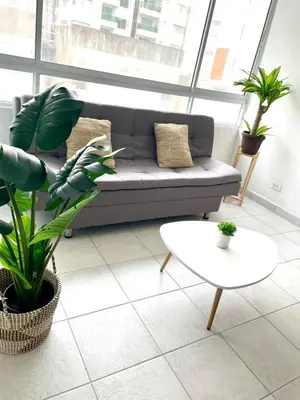 a living room with a couch and a table and plants at Oceanfront accommodation! in Cartagena de Indias
