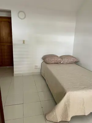 a bed with two pillows on it in a room at Oceanfront accommodation! in Cartagena de Indias