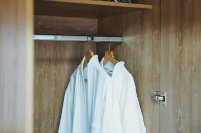 a group of white shirts hanging on a rack at Suite Premium con Terraza y Jacuzzi Privado in Cartagena de Indias