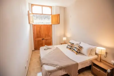 a small bedroom with a bed with a window at Historic Getaway with Breakfast in Cartagena de Indias