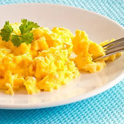 a plate of macaroni and cheese with a fork at Historic Getaway with Breakfast in Cartagena de Indias