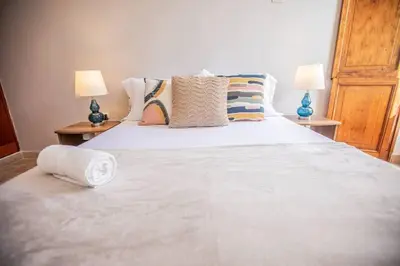 a bedroom with a large white bed with pillows at Historic Getaway with Breakfast in Cartagena de Indias