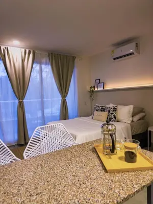 a bedroom with a bed and a table with a tray at Aparta Suite en Santamarina - Escápate al Caribe in Santa Marta