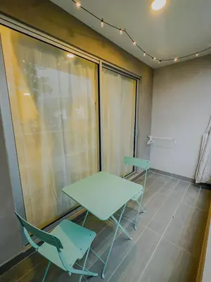 a table and chairs in a room with a window at Aparta Suite en Santamarina - Escápate al Caribe in Santa Marta