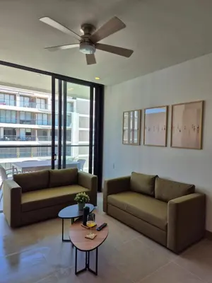 a living room with two couches and a ceiling fan at Apartamento moderno con vista al mar y piscinas 1 habitación con balcón en Manzanillo,Cartagena in Cartagena de Indias