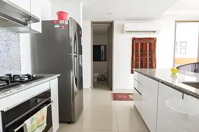 a kitchen with a stainless steel refrigerator and white cabinets at Lujoso Apto de 1 Habitación en Piso 14-Morros City in Cartagena de Indias