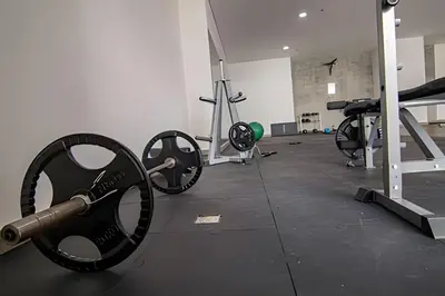 a gym with a bunch of weights in a room at 16th Floor Infinitum 1 Bedroom Apt in Cartagena de Indias