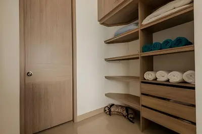 a walk in closet with wooden shelves and a door at 16th Floor Infinitum 1 Bedroom Apt in Cartagena de Indias