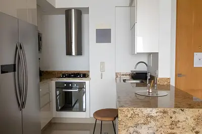 a kitchen with a stainless steel refrigerator and a counter at Lujoso Apto de 1 Habitación en Piso 17 -H2 Hyatt in Cartagena de Indias