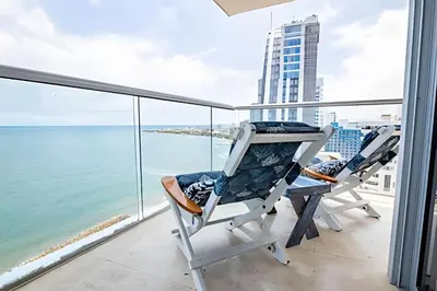two chairs on a balcony with a view of the ocean at Espectacular Vista desde Piso 17 -Morros City 1701 in Cartagena de Indias