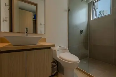 a bathroom with a toilet and a sink and a shower at Hermoso Apto - 2 Hab Piso- 17 Murano Elite in Cartagena de Indias
