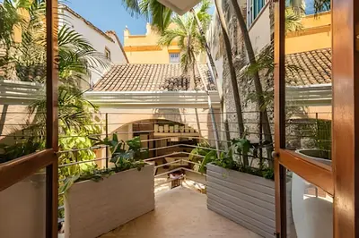an internal courtyard of a building with potted plants at Casa de 3 Hab en la Ciudad Amurallada con Piscina in Cartagena de Indias