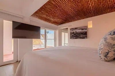 a bedroom with a large bed with a wooden ceiling at Casa Bóvedas - Paraíso de 5 habitaciones in Cartagena de Indias