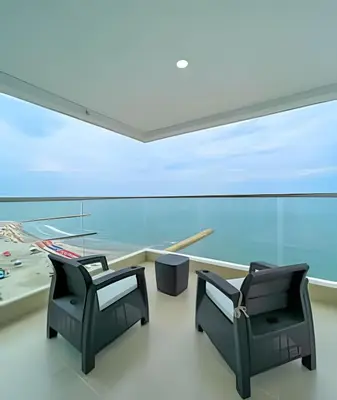 two chairs in a room with a large window at 1705 Palmetto Beach -17th Floor Palmetto Beach in Cartagena de Indias