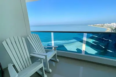 two chairs on a balcony with a view of the ocean at Espectacular Vista Al Mar - Edificio Infinito 1802 in Cartagena de Indias