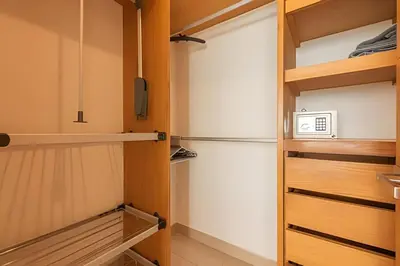 a kitchen with wooden cabinets and a refrigerator at Lujoso Apto con Vista al Mar - H2 Hyatt 1806 in Cartagena de Indias