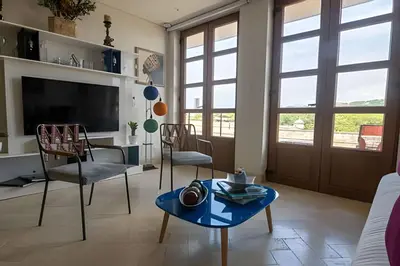 a living room with a tv and a table and chairs at Espectacular Vista al Castillo de San Felipe! in Cartagena de Indias