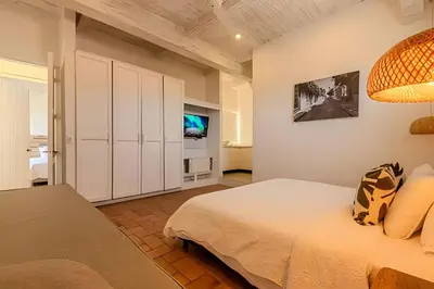 a bedroom with a bed and a tv in it at Casa de 5 Hab en la Ciudad Amurallada con Piscina in Cartagena de Indias