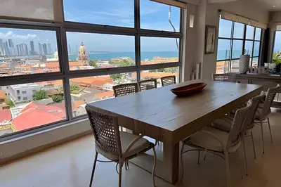 a dining room table with chairs and a large window at Espectacular apto de 2 hab en Centro Histórico in Cartagena de Indias