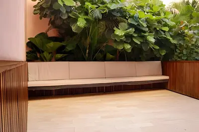 a bench in front of a wall of plants at Relaxing New Apt w/ Balcony in Getsemani! in Cartagena de Indias
