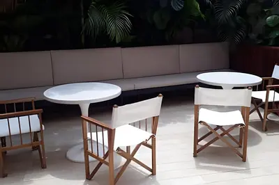 a row of tables and chairs in a restaurant at Relaxing New Apt w/ Balcony in Getsemani! in Cartagena de Indias