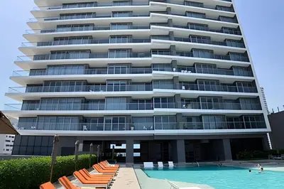 a large apartment building with a swimming pool and lounge chairs at Morros City-Espectacular Apto Vista al Mar Piso 8 in Cartagena de Indias