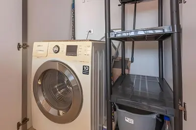 a washing machine in a laundry room with a shelf at El Mirador de la Catedral - Centro Histórico in Cartagena de Indias
