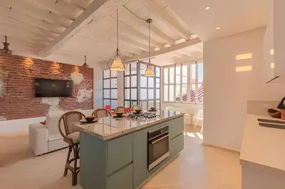 a kitchen with an island in the middle of a room at El Mirador de la Catedral - Centro Histórico in Cartagena de Indias