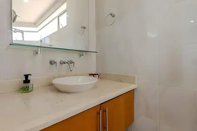 a bathroom with a white sink and a mirror at Espectacular Vista Al Mar - Ed. Infinito 2302 in Cartagena de Indias