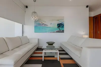 a white living room with white couches and a table at Espectacular Vista Al Mar - Ed. Infinito 2302 in Cartagena de Indias