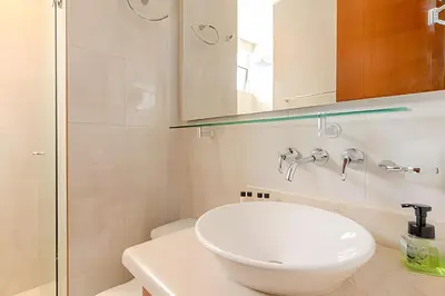a bathroom with a white toilet and a sink at Espectacular Vista Al Mar - Ed. Infinito 2302 in Cartagena de Indias