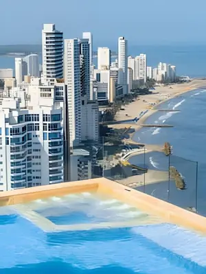 a swimming pool with a view of the beach and buildings at Lujoso Apto de 1 Habitación en Piso 24-Murano E in Cartagena de Indias