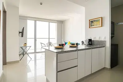 a kitchen with white cabinets and a counter at Lujoso Apto de 1 Habitación en Piso 40-Morros City in Cartagena de Indias