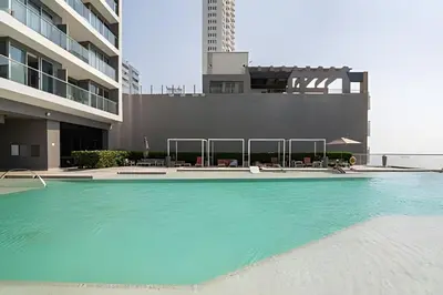 a swimming pool with blue water in front of a building at Lujoso Apto de 1 Habitación en Piso 40-Morros City in Cartagena de Indias