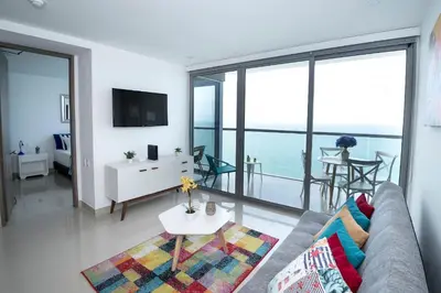 a living room with a couch and a view of the ocean at Espectacular Apto 1 Hab en Bocagrande - 2504 in Cartagena de Indias