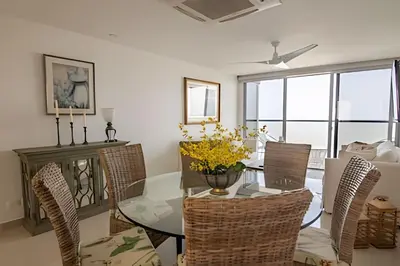 a dining room with a glass table and chairs at Lujoso Apto de 2 Hab en piso 26 - Morros City in Cartagena de Indias
