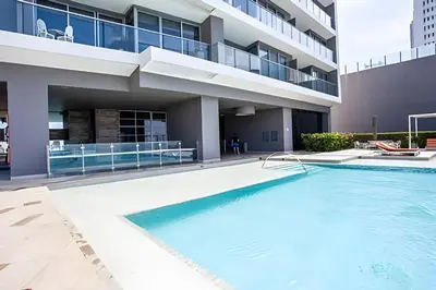 a swimming pool in front of a building at Espectacular Apto de 2 Hab en Piso 27-Morros City in Cartagena de Indias