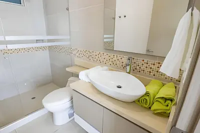 a white bathroom with a sink and a toilet at Lujoso Apto Vista al Mar Piso 34 - Palmetto Beach in Cartagena de Indias