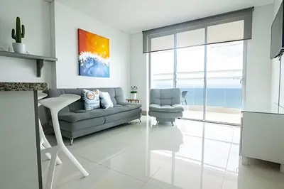a living room with a couch and a chair at Lujoso Apto Vista al Mar Piso 34 - Palmetto Beach in Cartagena de Indias