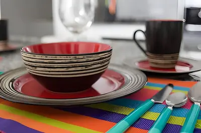 a colorful table with plates and cups and spoons at Lujoso Apto de 1 habitacion en piso 29-Morros City in Cartagena de Indias