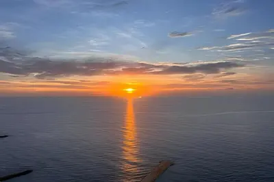 a sunset over the ocean with the sun in the sky at Espectacular apt en el piso 29 en Palmetto Beach in Cartagena de Indias