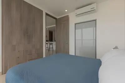 a bedroom with a blue bed in a room at Lujoso Apto de 2 Habitaciones Piso 32- Morros City in Cartagena de Indias