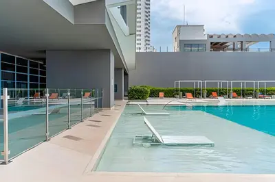 a swimming pool on the side of a building at Lujoso Apto de 2 Habitaciones Piso 32- Morros City in Cartagena de Indias